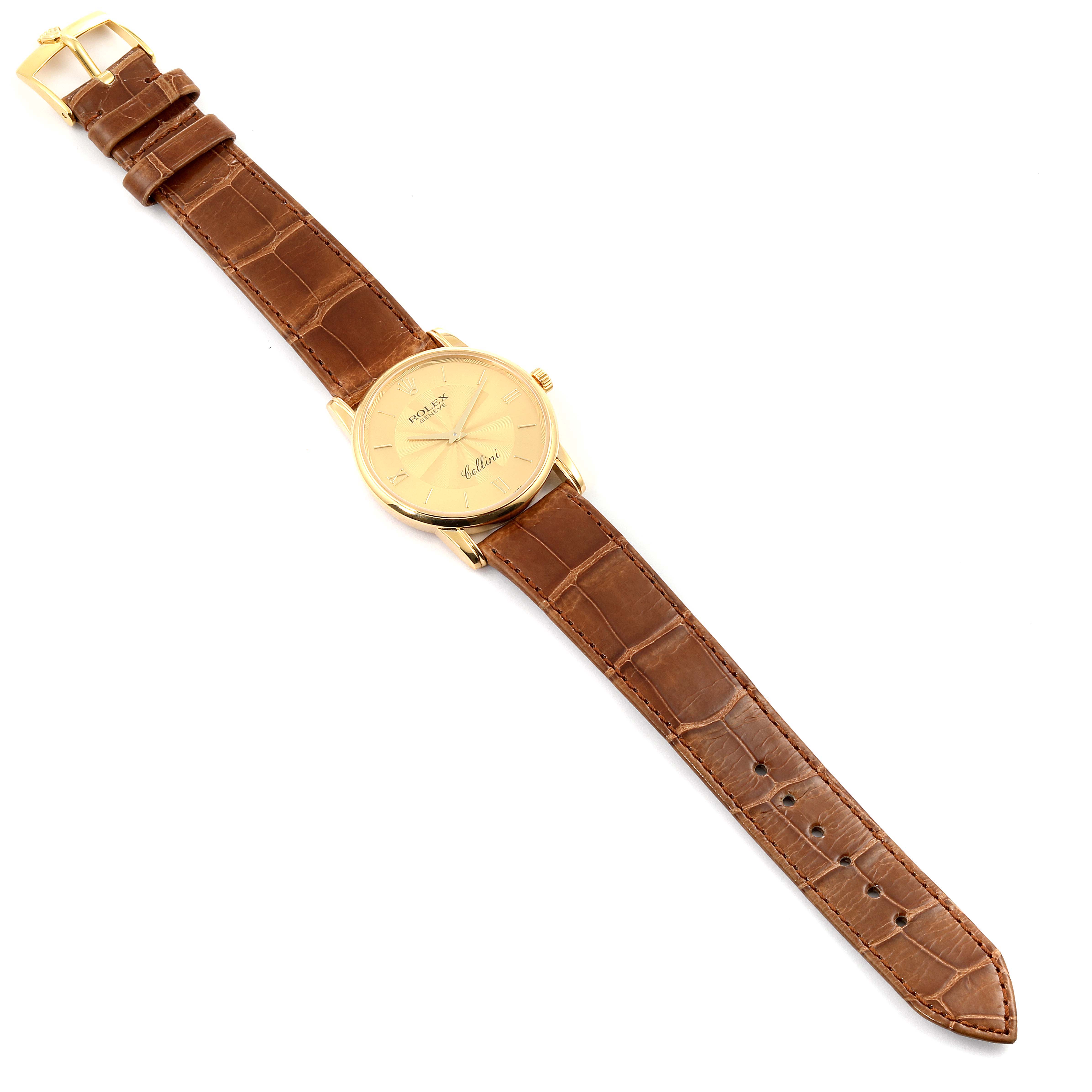 The Rolex Cellini 5116 Men's Yellow Gold Champagne Dial 5116 Men's Yellow Gold Champagne Dial watch is shown from a top-down angle, displaying the dial, bezel, case, crown, and leather strap.