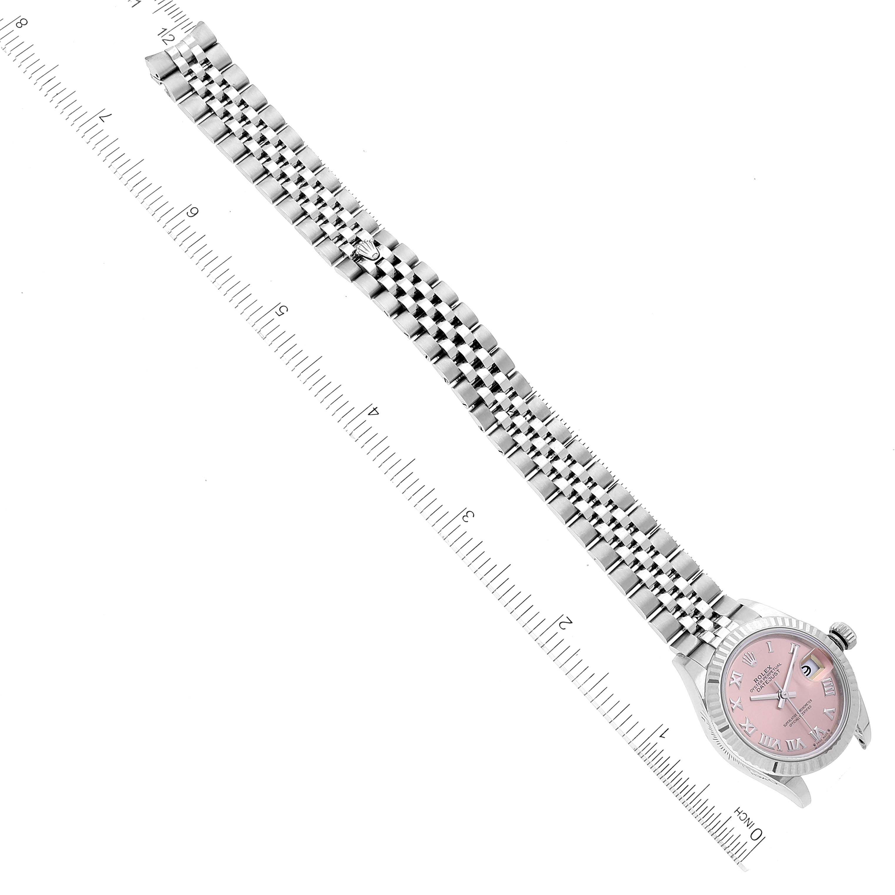The image shows a Rolex Datejust 279174 Women's Stainless Steel Pink Dial 279174 Women's Stainless Steel Pink Dial watch laid flat with its stainless steel bracelet and pink dial visible, placed alongside a ruler for scale.