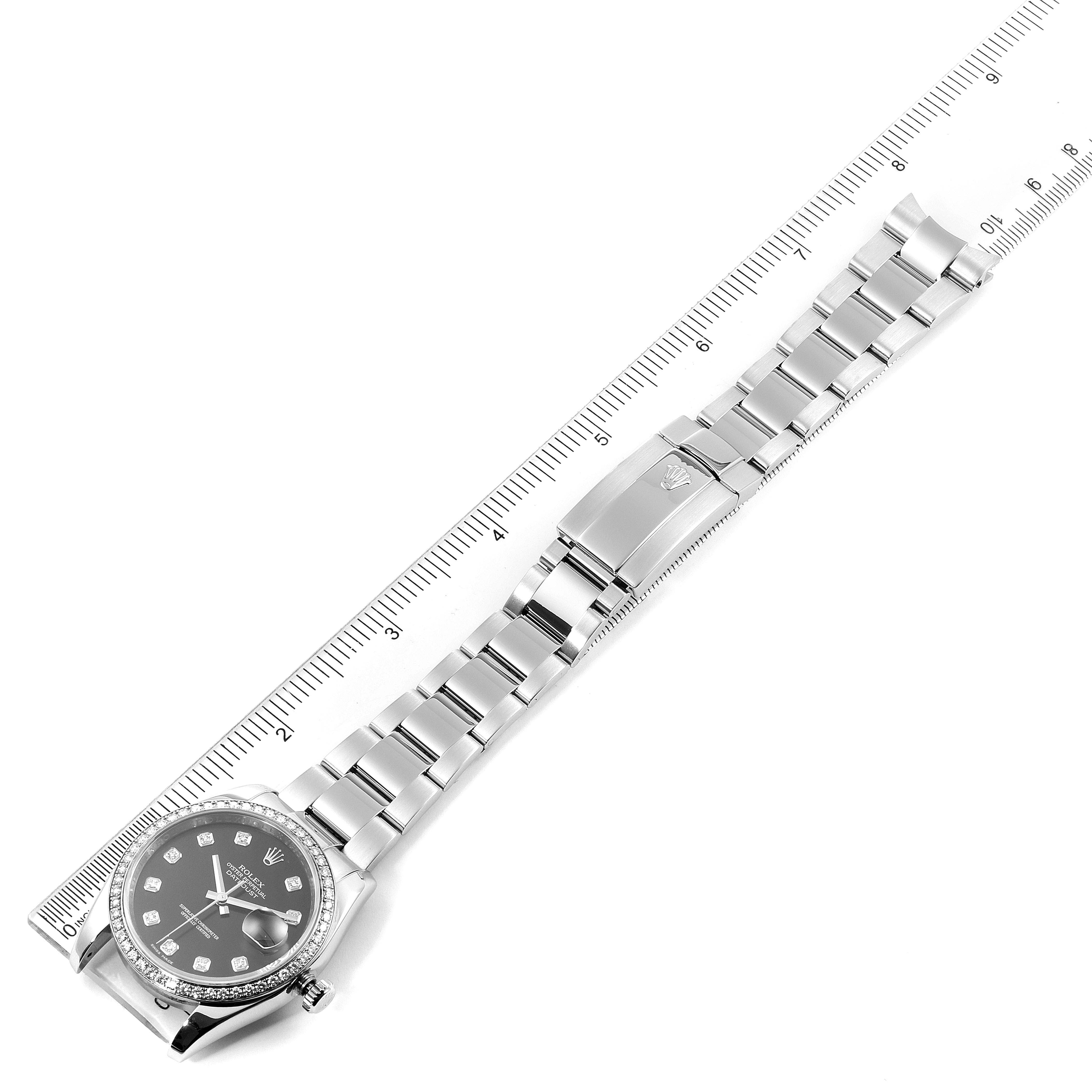 The image shows a Rolex Datejust 116244 Men's Stainless Steel Black Dial 116244 Men's Stainless Steel Black Dial watch from an overhead angle, displaying its face, bracelet, and clasp next to a ruler.