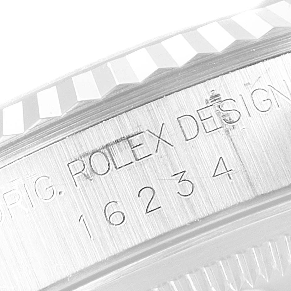The image shows a close-up of the side of a Rolex Datejust 16234 Men
s Stainless Steel Black Dial 16234 Men
s Stainless Steel Black Dial model, highlighting the engraved design information and serial number 16234.