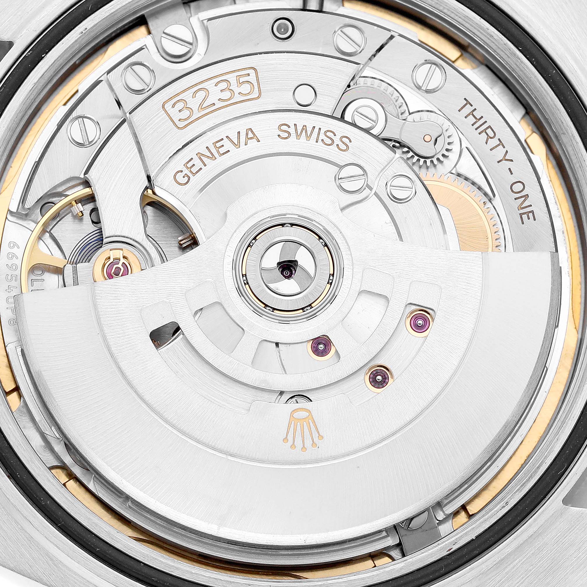 The image shows an up-close view of the movement mechanism of the Rolex Datejust 41 126334 Men
s Stainless Steel Mother of Pearl Dial 126334 Men
s Stainless Steel Mother of Pearl Dial watch, highlighting the intricate components and engravings.
