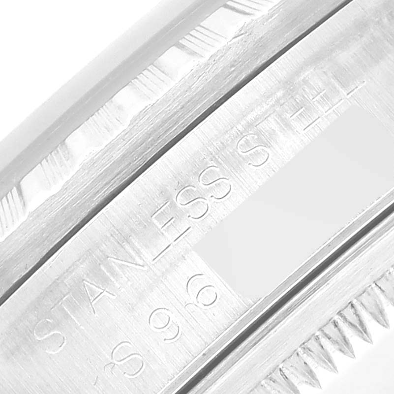 The image shows an angled close-up of the engraved stainless steel bezel of a Rolex Datejust 16220 Men's Stainless Steel Black Dial 16220 Men's Stainless Steel Black Dial watch.