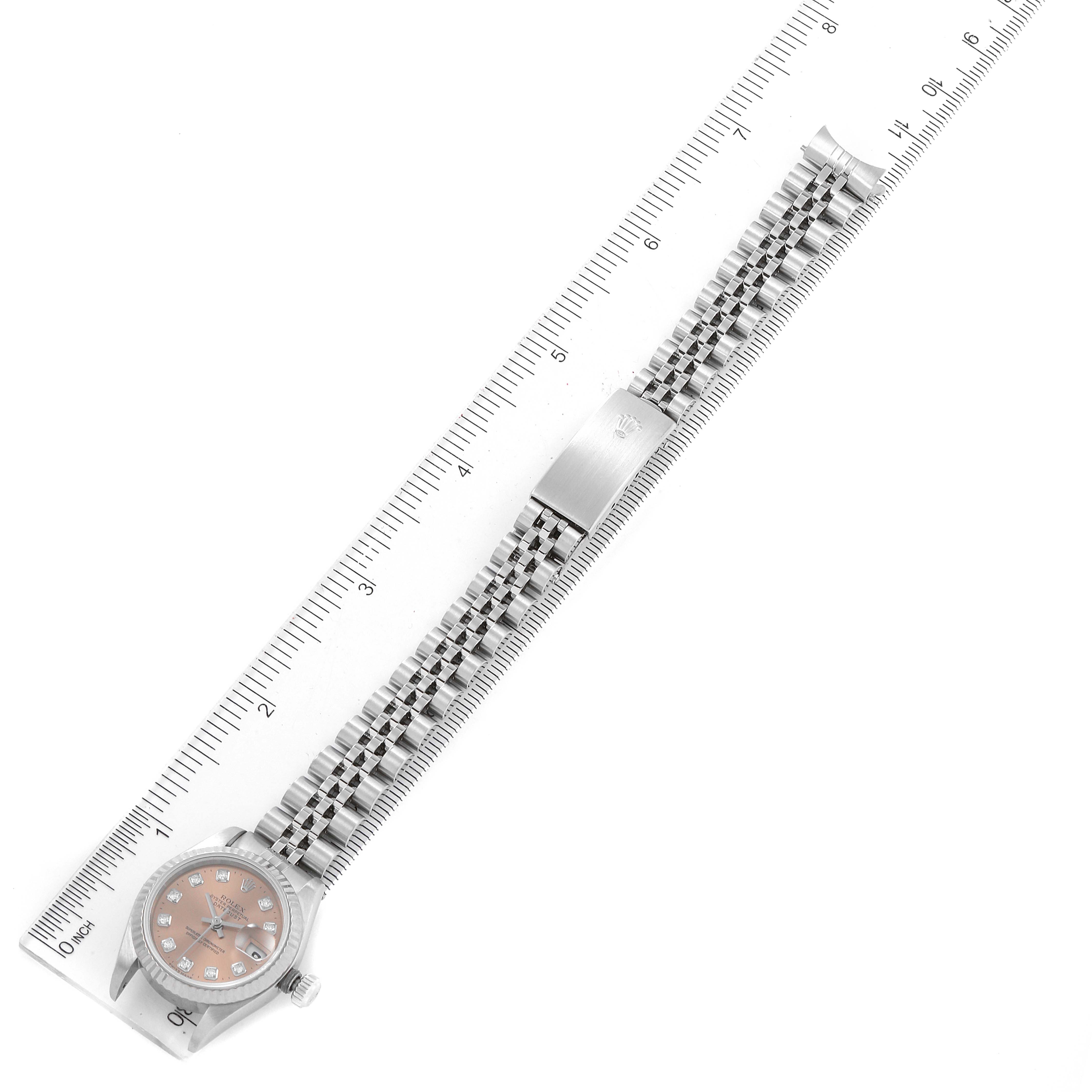 The image shows a Rolex Datejust 79174 Women's Stainless Steel Pink Dial 79174 Women's Stainless Steel Pink Dial watch laid flat with a ruler displaying the full length of the watch and bracelet.