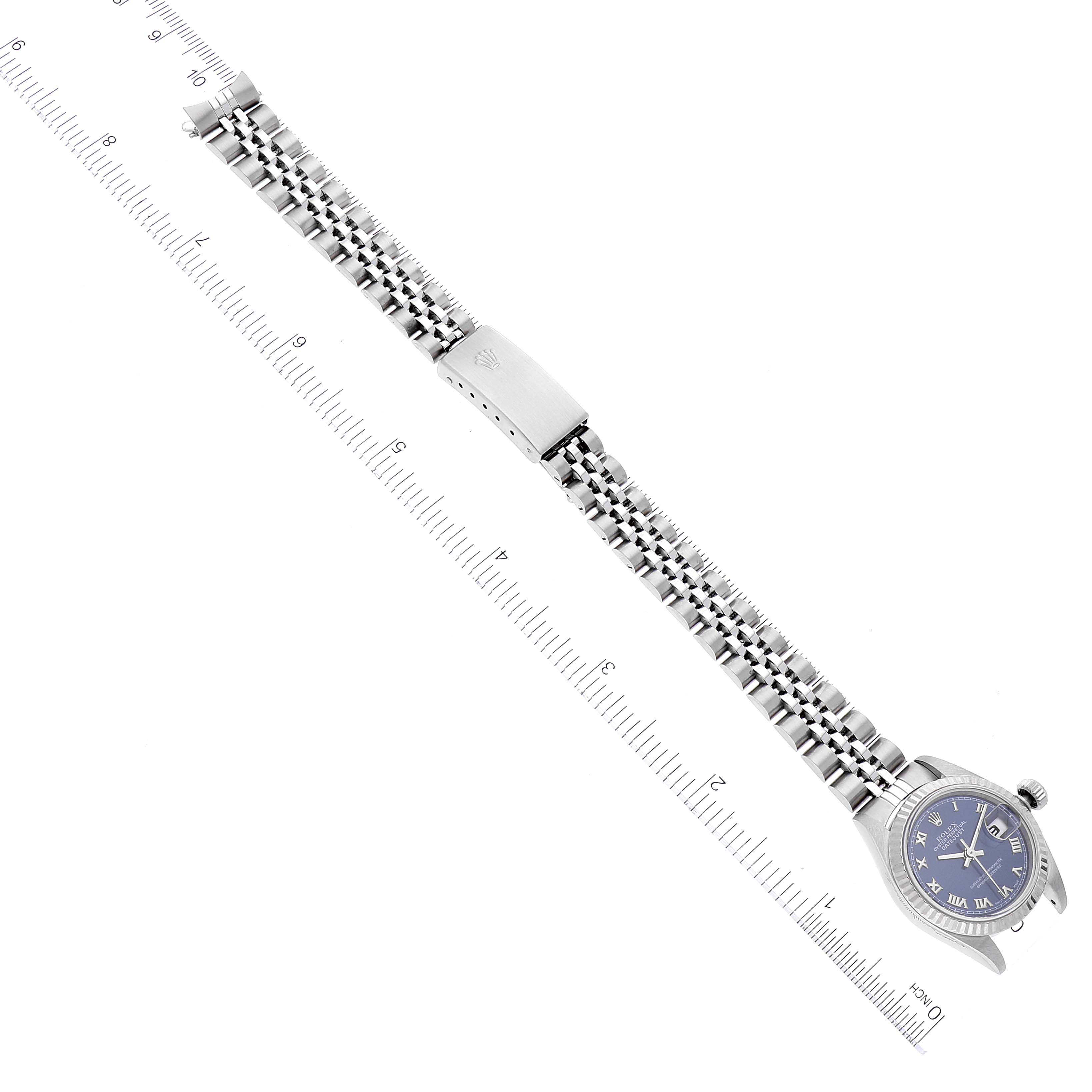 The image shows a Rolex Datejust 79174 Women's Stainless Steel Blue Dial 79174 Women's Stainless Steel Blue Dial watch laid flat, displaying the bracelet, clasps, and dial with a ruler next to it for measurement.