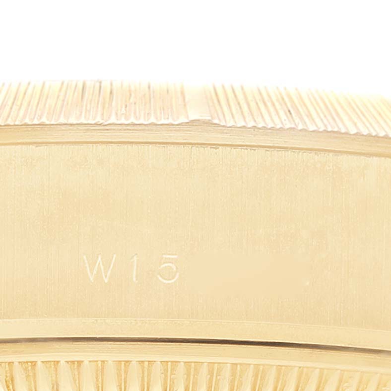 This close-up image shows the side of a Rolex President 69278 Women's Yellow Gold Champagne Dial 69278 Women's Yellow Gold Champagne Dial watch, highlighting the engravings and detailed edge.
