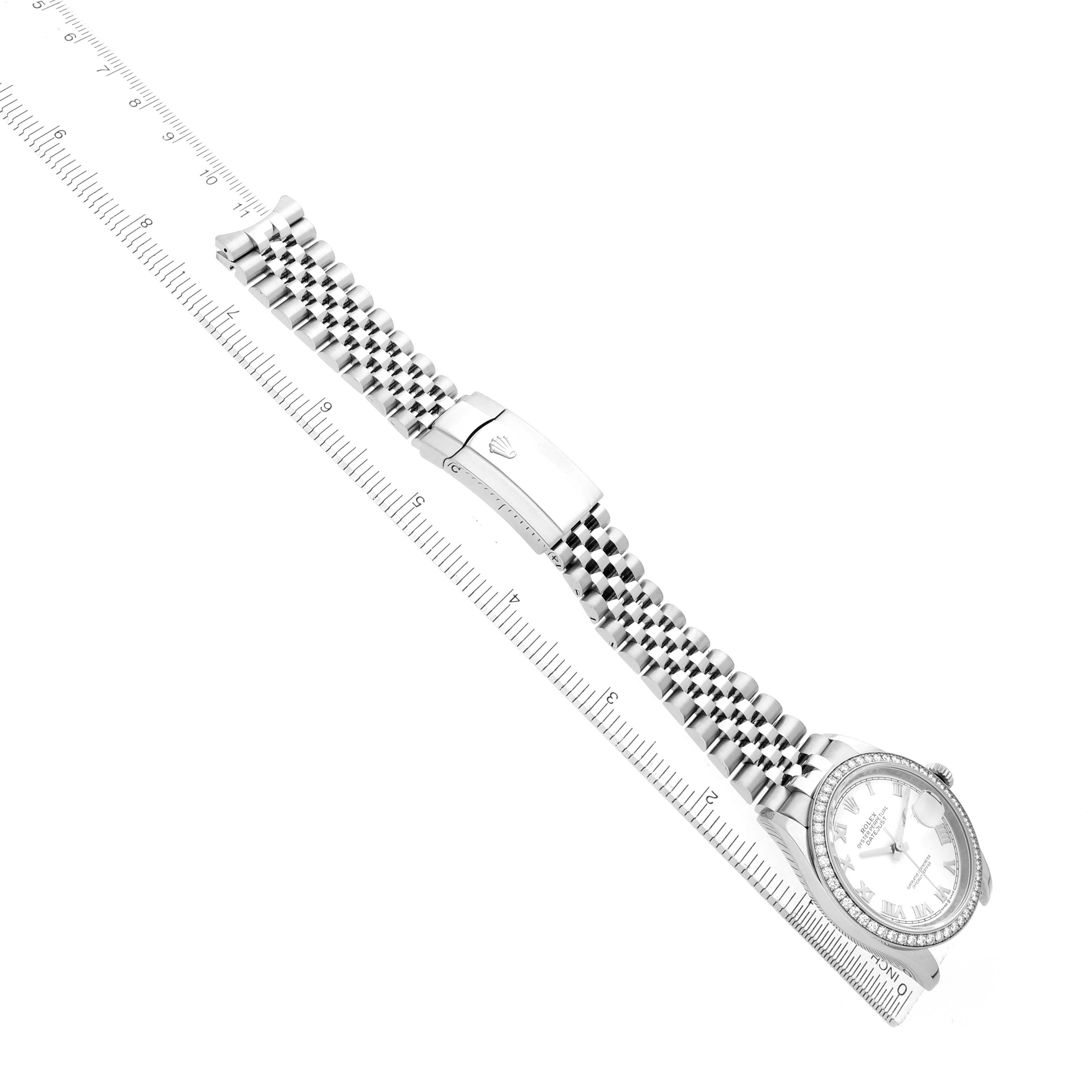 The Rolex Datejust 126284 Men's Stainless Steel White Dial watch is shown from a top-down angle, highlighting its bracelet, clasp, and face alongside a ruler.