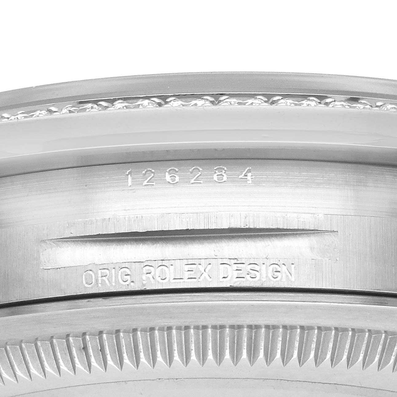 The image shows the side view of the case and bezel of a Rolex Datejust 126284 Men's Stainless Steel White Dial, featuring engraved model details.