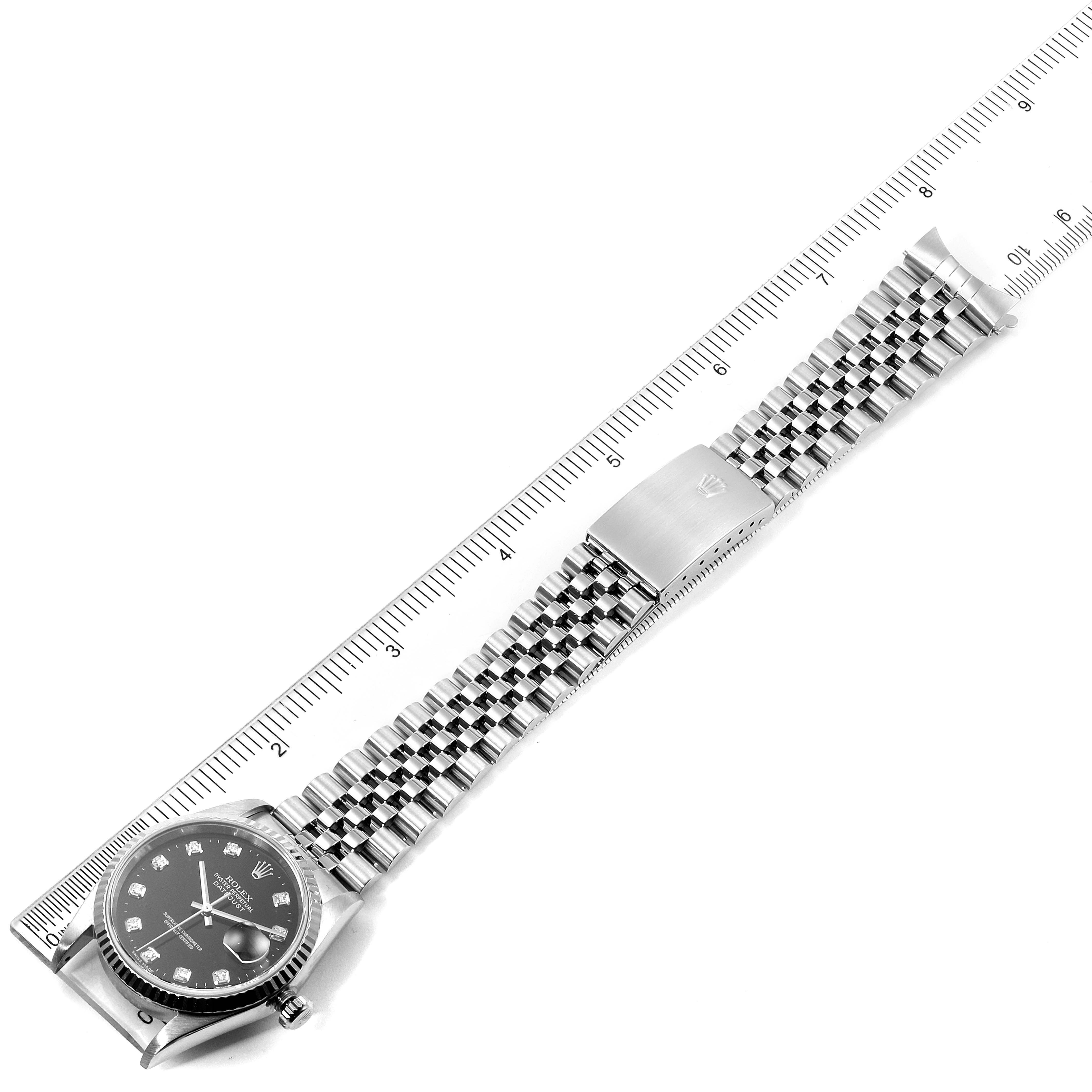 The image shows a top-down view of a Rolex Datejust 16234 Men's Stainless Steel Black Dial 16234 Men's Stainless Steel Black Dial watch, displaying the dial, bracelet, and clasp, with a ruler for scale.