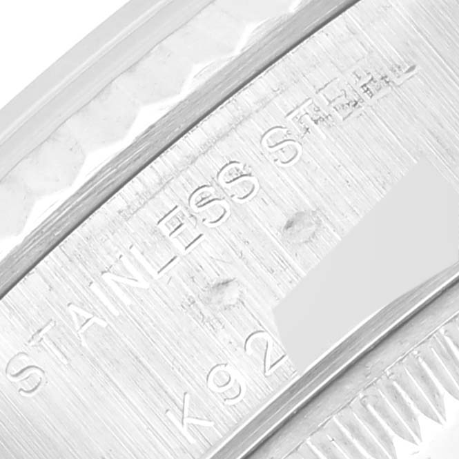 This close-up shows a part of the stainless steel case with some inscriptions of the Rolex Datejust 79174 Women's Stainless Steel Silver Dial 79174 Women's Stainless Steel Silver Dial watch.