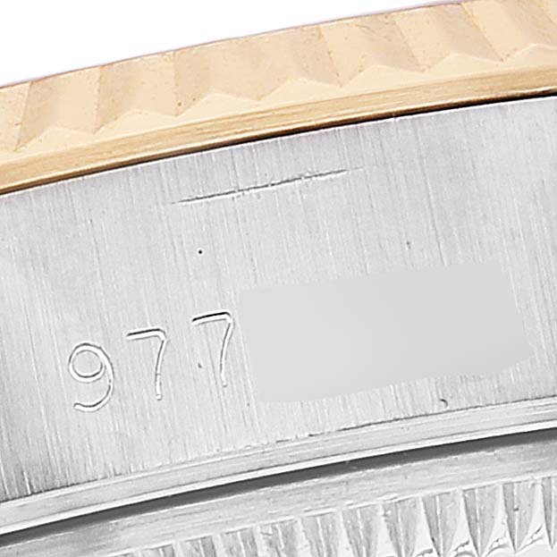 The image shows a macro shot of the case edge and bezel of a Rolex Datejust 69173 Women's Steel and Gold (two tone) Champagne Dial 69173 Women's Steel and Gold (two tone) Champagne Dial watch, including part of its serial number.