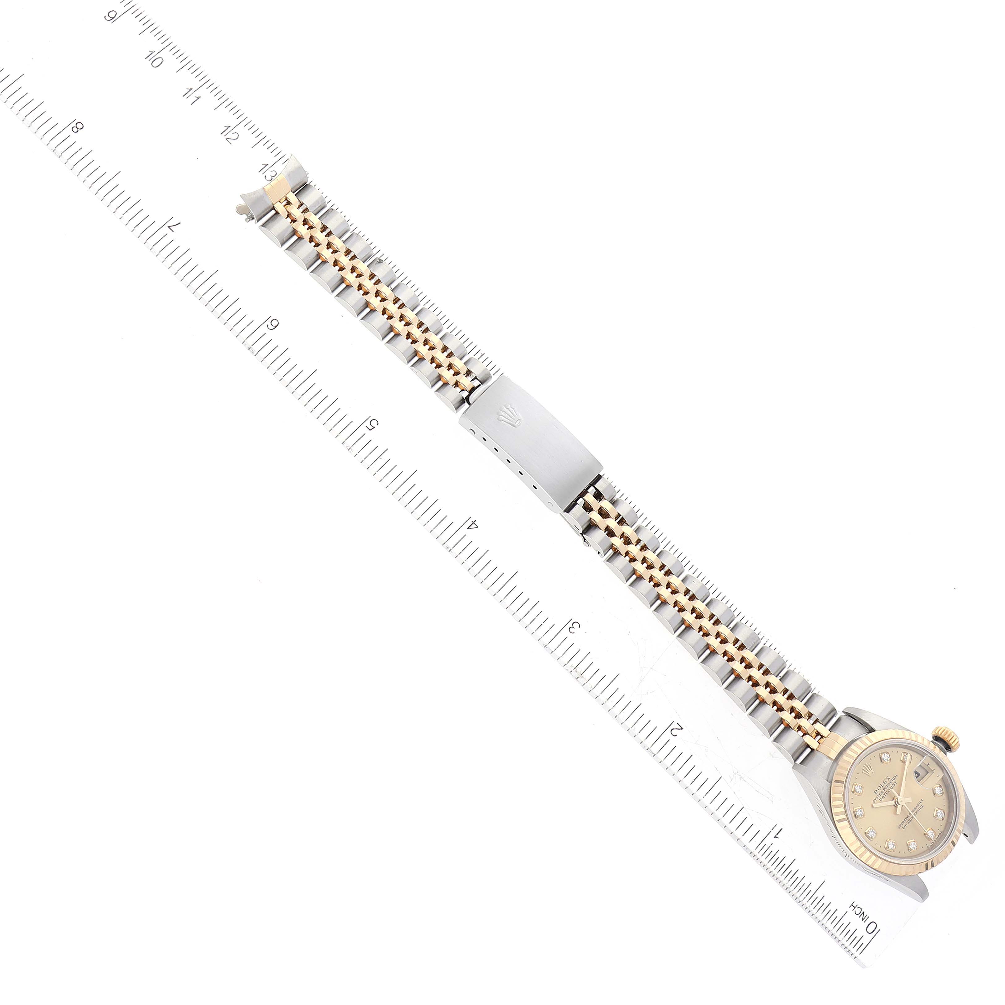 The image shows a Rolex Datejust 79173 Women's Steel and Gold (two tone) Champagne Dial 79173 Women's Steel and Gold (two tone) Champagne Dial watch laid flat with the dial partially visible and a ruler next to the band for measurement.