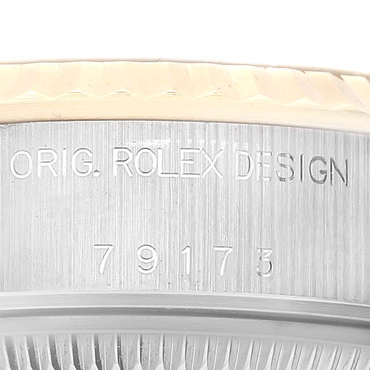 Close-up view of the model number and "ORIG. ROLEX DESIGN" engraving on a Rolex Datejust 79173 Women's Steel and Gold (two tone) Champagne Dial 79173 Women's Steel and Gold (two tone) Champagne Dial watch case.