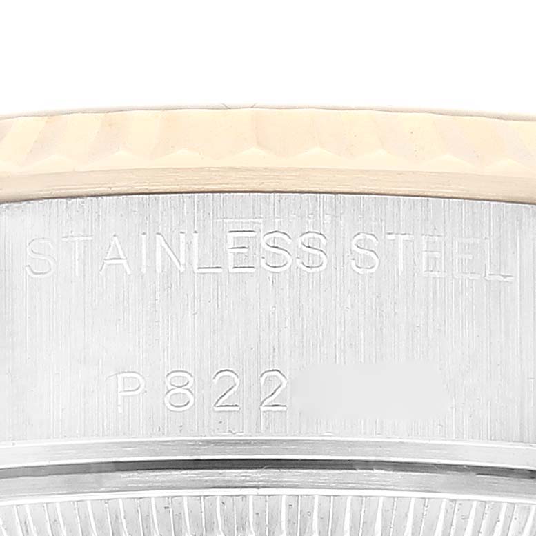 This image shows the engraved stainless steel side and part of the fluted bezel of a Rolex Datejust 79173 Women's Steel and Gold (two tone) Champagne Dial 79173 Women's Steel and Gold (two tone) Champagne Dial watch.