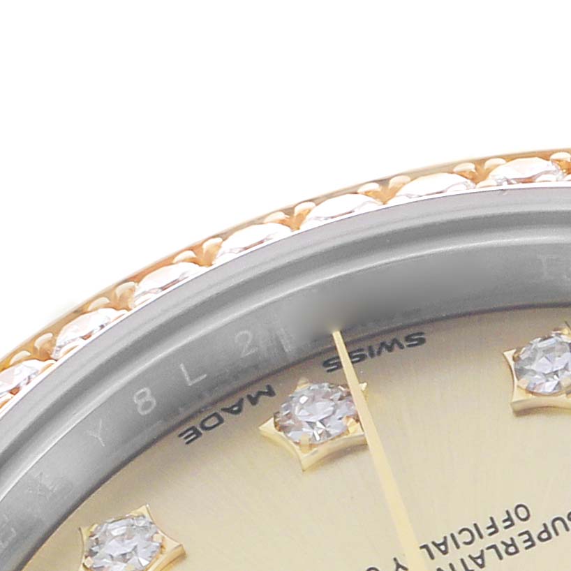 This close-up of the Rolex Datejust 279383RBR Women's Steel and Gold (two tone) Champagne Dial shows the bezel with diamonds, part of the dial, and diamond hour markers.