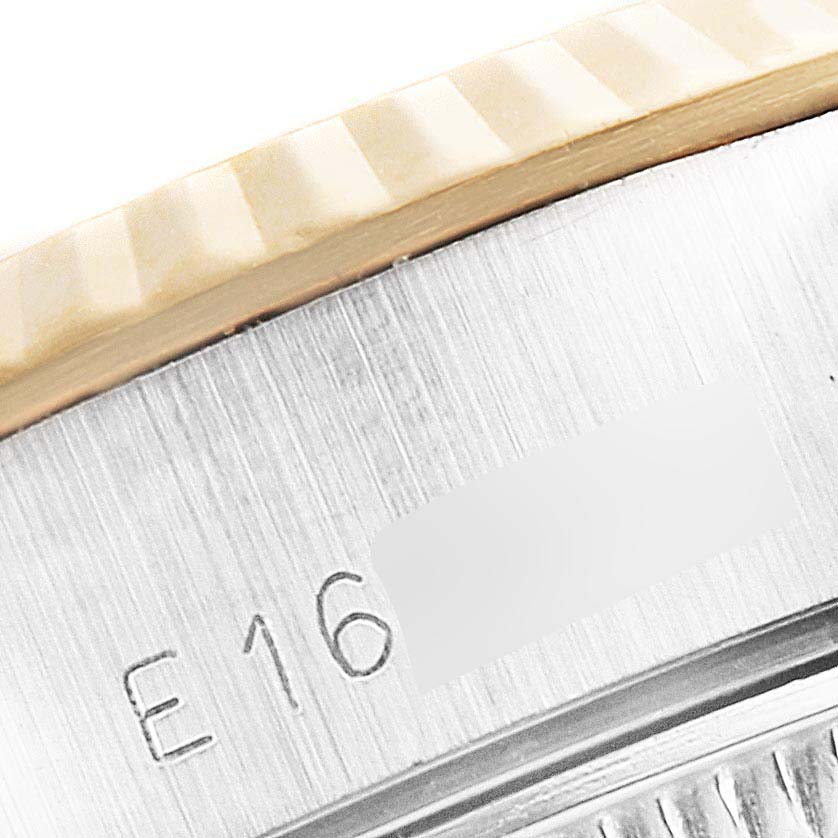 This close-up image shows a partial view of the fluted bezel and engraved case of a Rolex Datejust 69173 Women's Steel and Gold (two tone) Champagne Dial 69173 Women's Steel and Gold (two tone) Champagne Dial watch.