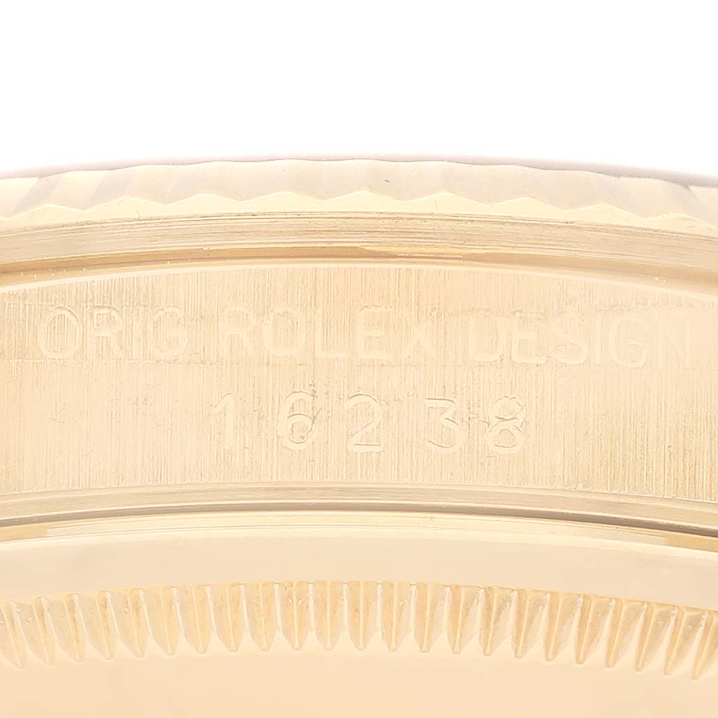 The image shows a close-up of the engraved bezel and case back of a Rolex President 16238 Men
s Yellow Gold Champagne Dial 16238 Men
s Yellow Gold Champagne Dial model watch.