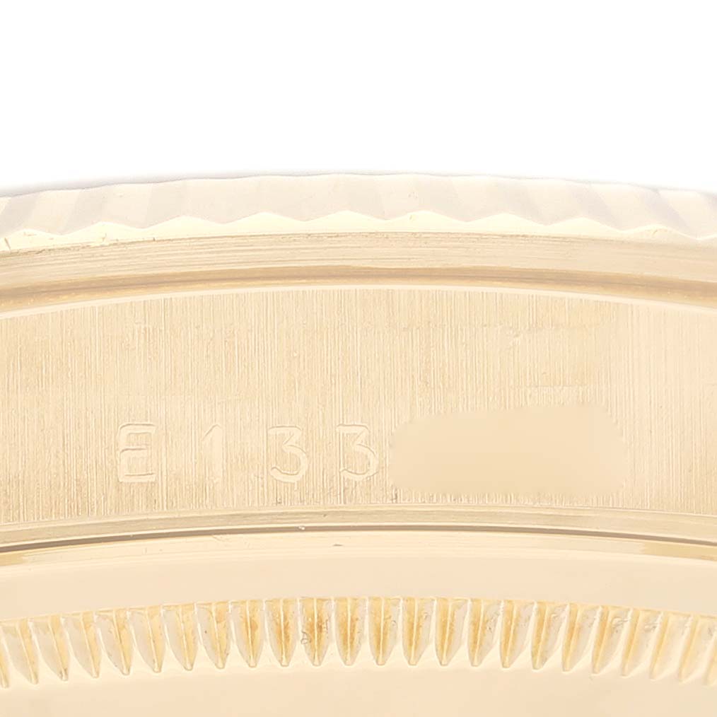 The image shows a close-up of the side and edge of the bezel of a Rolex President 16238 Men
s Yellow Gold Champagne Dial 16238 Men
s Yellow Gold Champagne Dial model watch, highlighting the serial number.