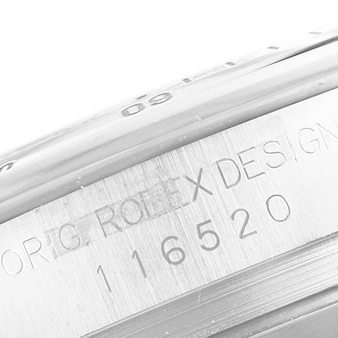 This image shows a close-up of the side of a Rolex Daytona 116520 Men's Stainless Steel Black Dial 116520 Men's Stainless Steel Black Dial watch, revealing the engraved model number "116520."