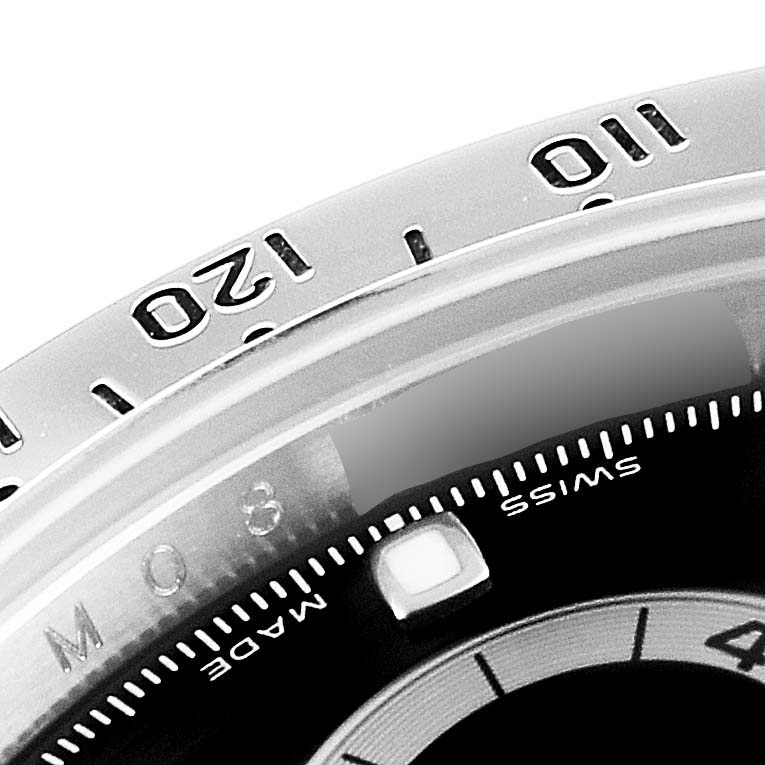 This close-up image shows the bezel and a portion of the dial of a Rolex Daytona 116520 Men's Stainless Steel Black Dial 116520 Men's Stainless Steel Black Dial watch.