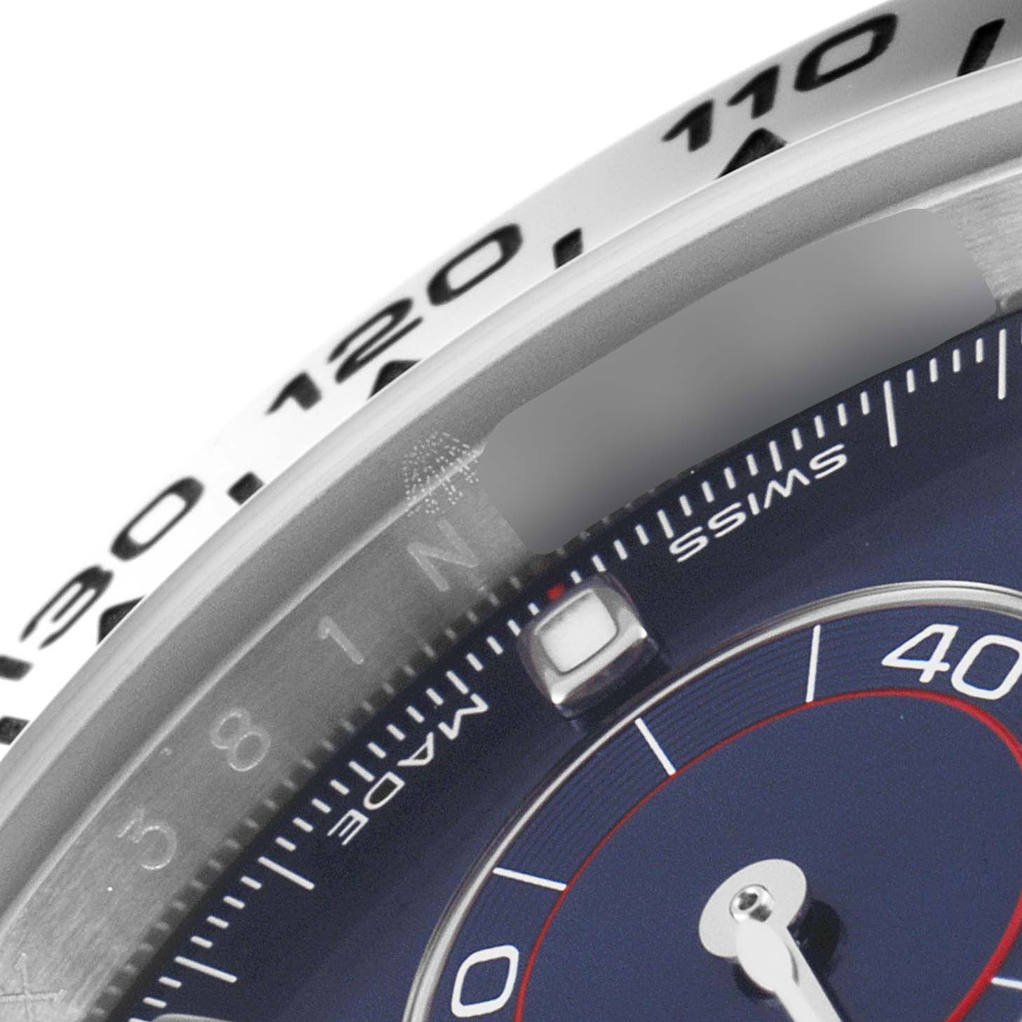 Close-up showing the bezel and dial of a Rolex Daytona 116509 Men's White Gold Blue Dial 116509 Men's White Gold Blue Dial watch, including part of the tachymeter scale and markings.