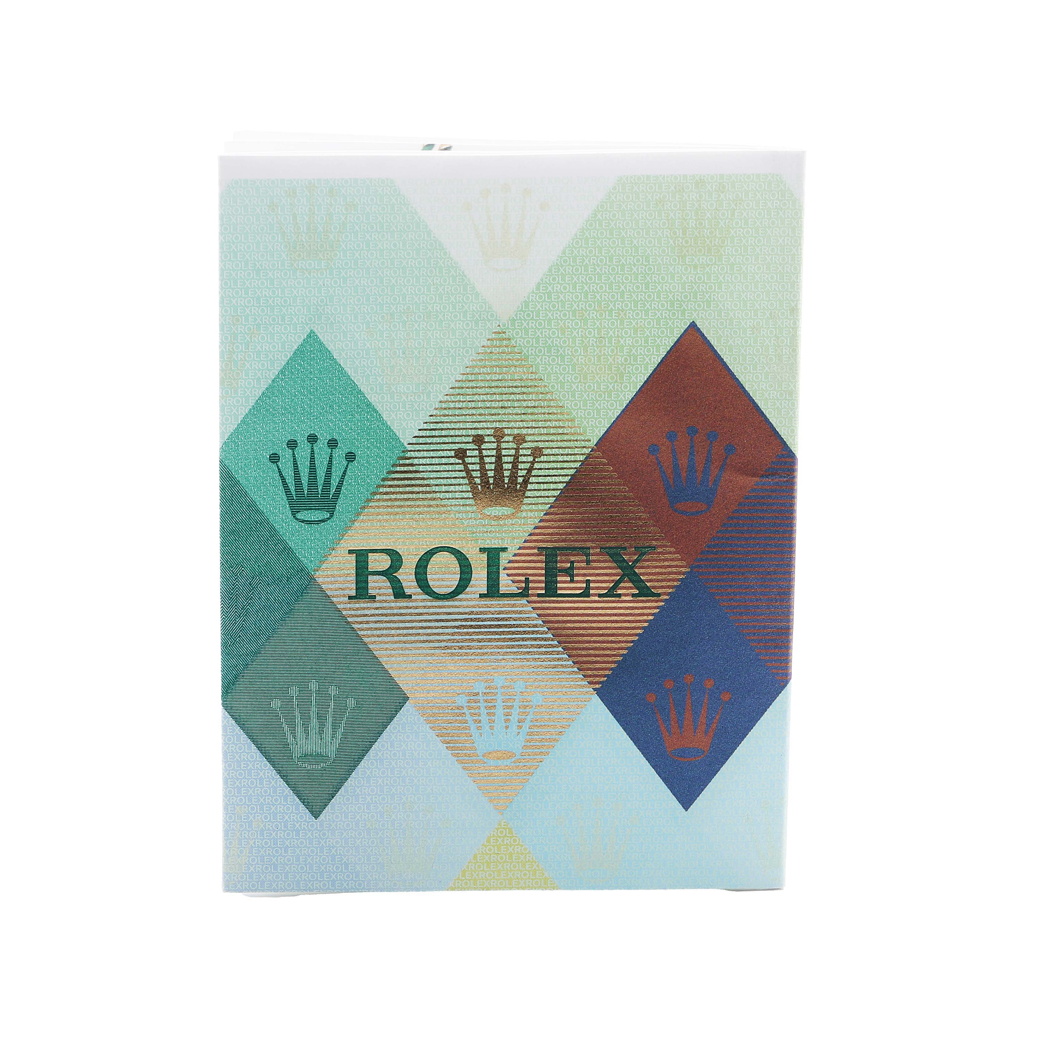 The image shows the packaging booklet for a Rolex Daytona 116520 Men's Stainless Steel Black Dial, featuring a geometric design with the Rolex logo and crown motifs.