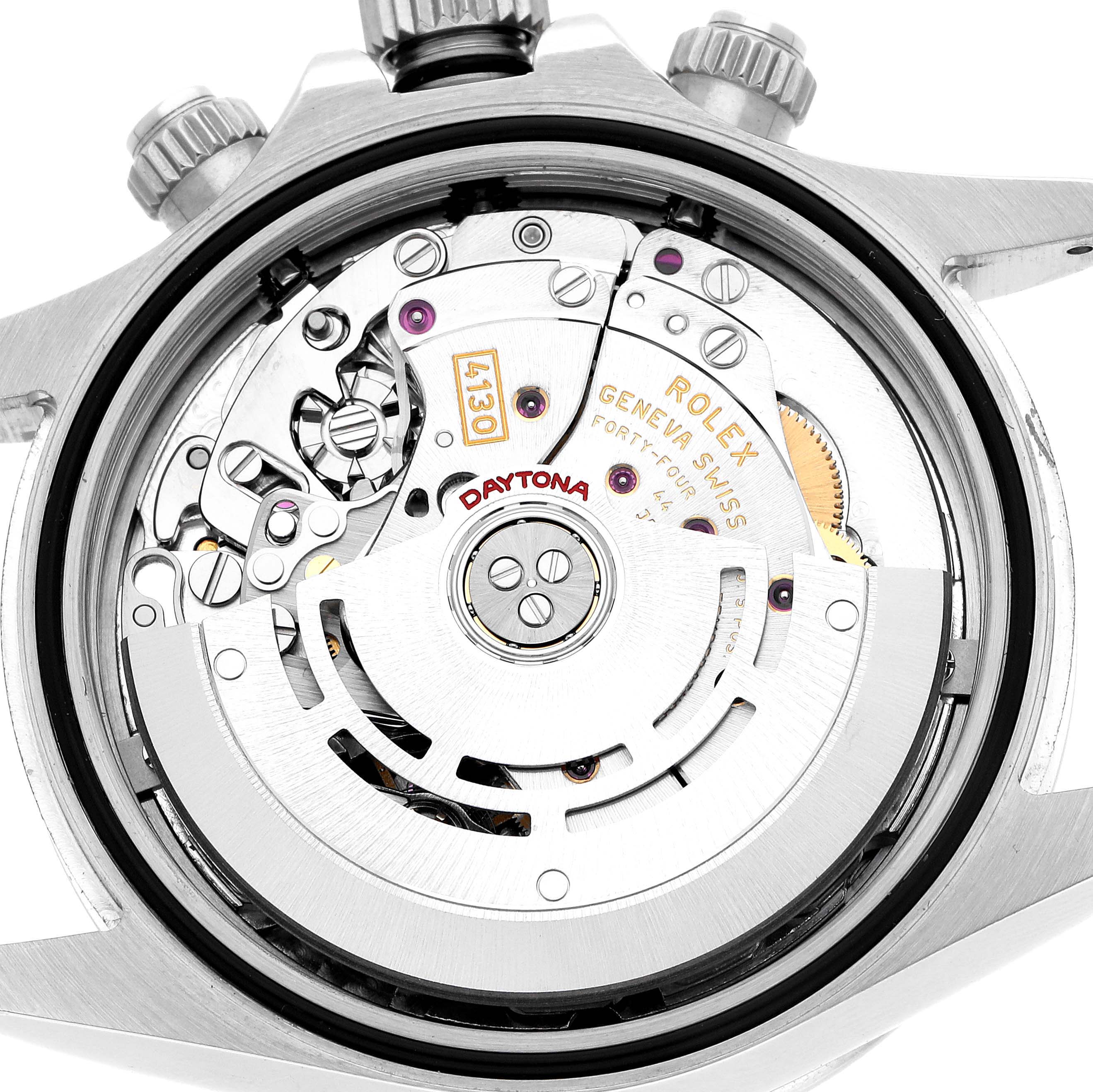 The image shows a close-up view of the Rolex Daytona 116520 Men's Stainless Steel Black Dial's movement, showcasing intricate gears and rotor details.