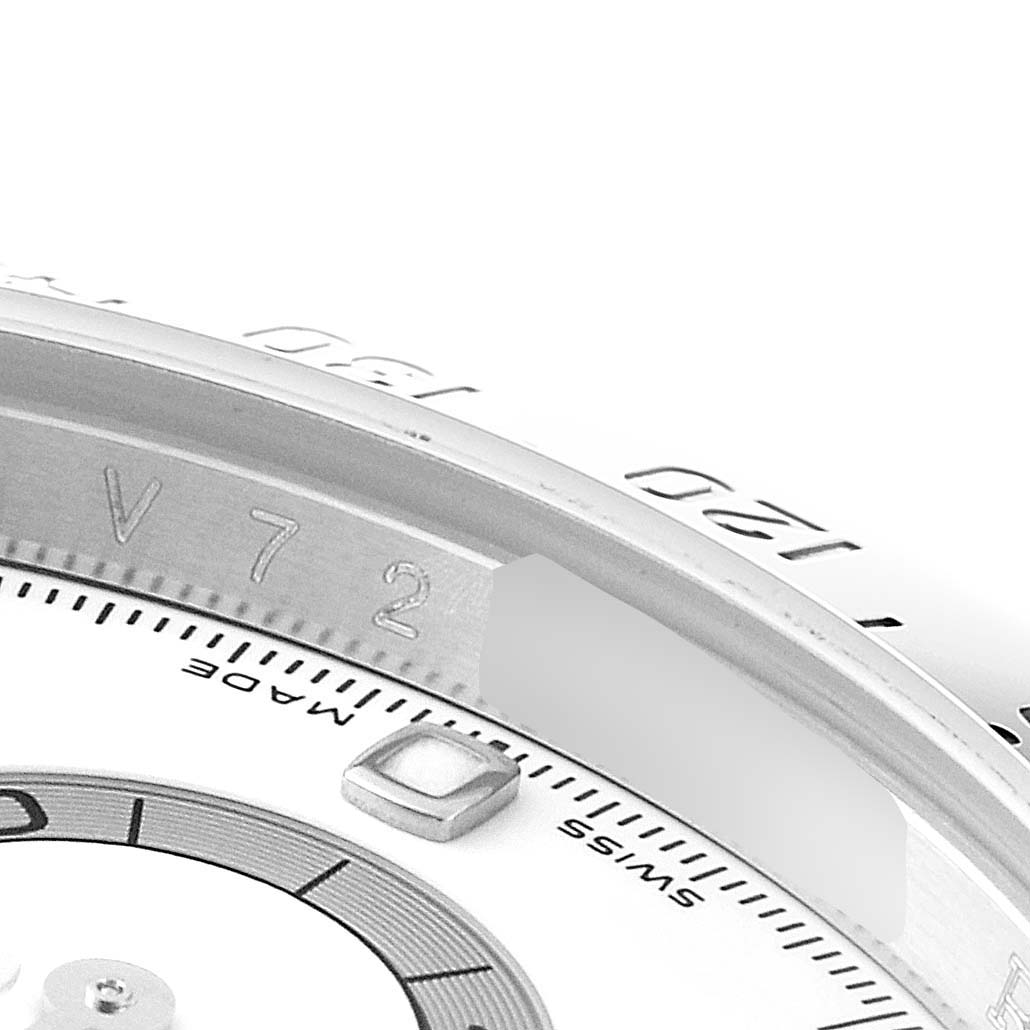 This close-up image shows the inner bezel and part of the dial of a Rolex Daytona 116520 Men's Stainless Steel White Dial 116520 Men's Stainless Steel White Dial watch.