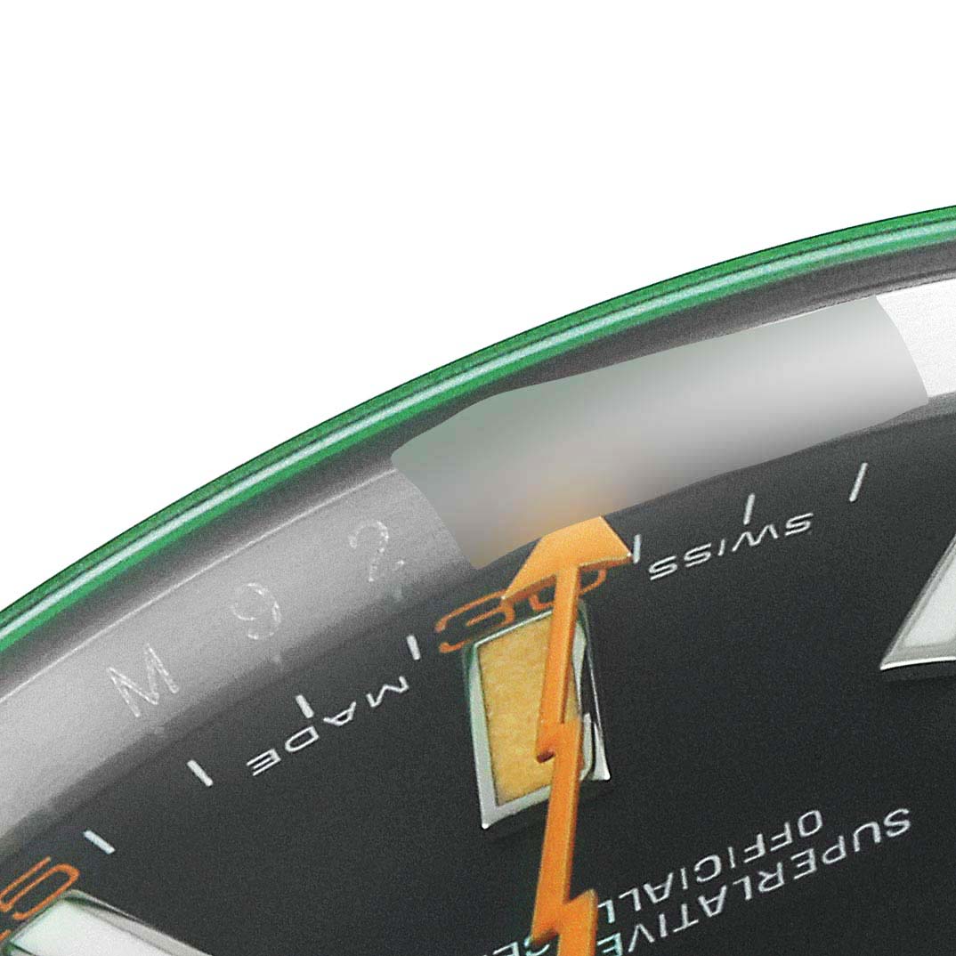 This close-up shows the face of the Rolex Milgauss 116400GV Men
s Stainless Steel Black Dial 116400GV Men
s Stainless Steel Black Dial watch, highlighting the green crystal edge, orange lightning bolt second hand, and partial markers.