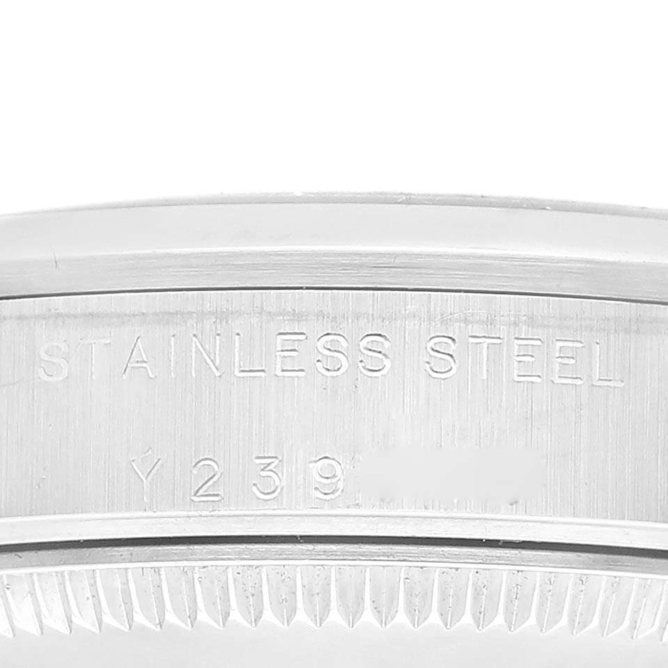 The image shows a close-up of the case back engraving on a Rolex Mid-Size 77080 Women
s Stainless Steel Black Dial 77080 Women
s Stainless Steel Black Dial model, highlighting "STAINLESS STEEL" and part of the serial number.