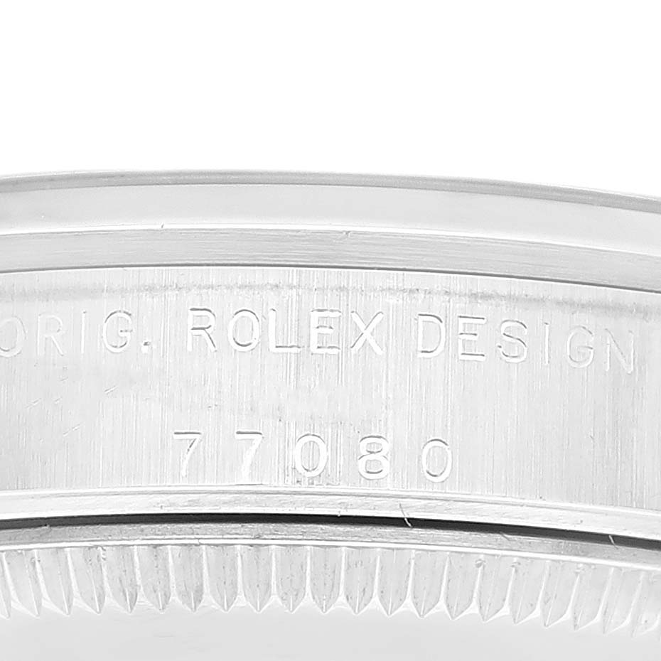 This image shows a close-up of the case back edge of a Rolex Mid-Size 77080 Women
s Stainless Steel Black Dial 77080 Women
s Stainless Steel Black Dial model, displaying the engraving "ORG. ROLEX DESIGN 77080".