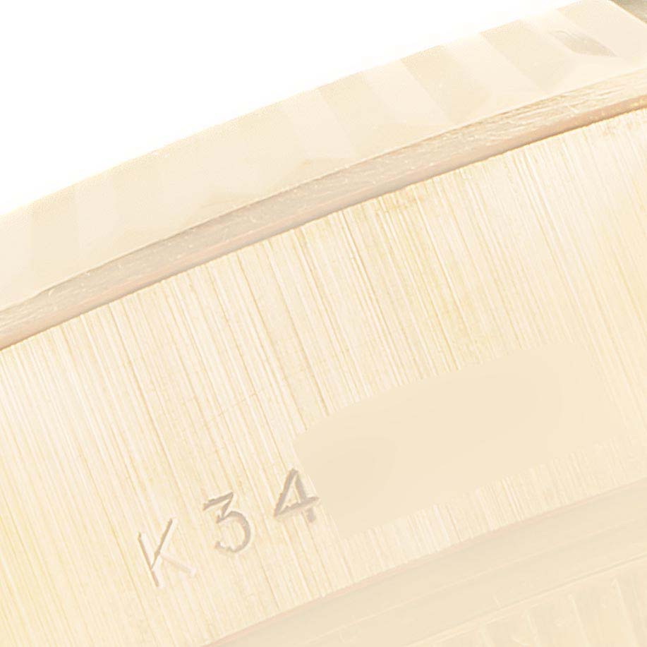 The image shows a close-up of the edge with engraved markings of a Rolex President 79178 Women's Yellow Gold Silver Dial 79178 Women's Yellow Gold Silver Dial model watch.