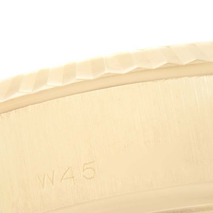 This close-up image focuses on the fluted bezel and case edge of the Rolex President 69178 Women
s Yellow Gold Champagne Dial 69178 Women
s Yellow Gold Champagne Dial model watch, showing partial engraving.