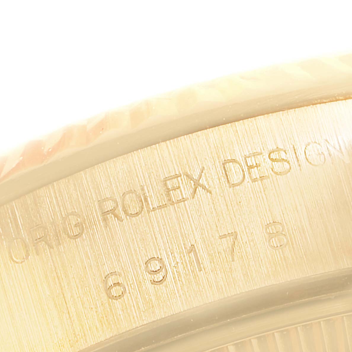 Close-up of the engraved serial number and bezel edge on a Rolex President 69178 Women
s Yellow Gold Champagne Dial 69178 Women
s Yellow Gold Champagne Dial model watch.