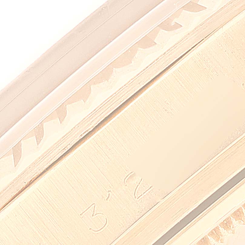 This close-up image of the Rolex President 1803 Men
s Yellow Gold Champagne Dial 1803 Men
s Yellow Gold Champagne Dial model watch shows a portion of the fluted bezel and case with partial engraved numbers.