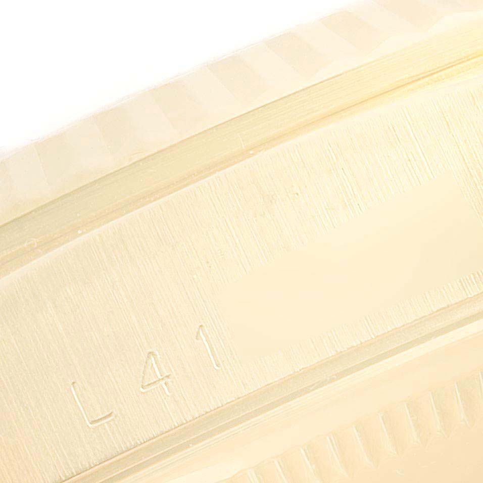 This image shows a close-up of the engraved side part of the bezel of a Rolex President 18238 Men's Yellow Gold Champagne Dial 18238 Men's Yellow Gold Champagne Dial model watch.