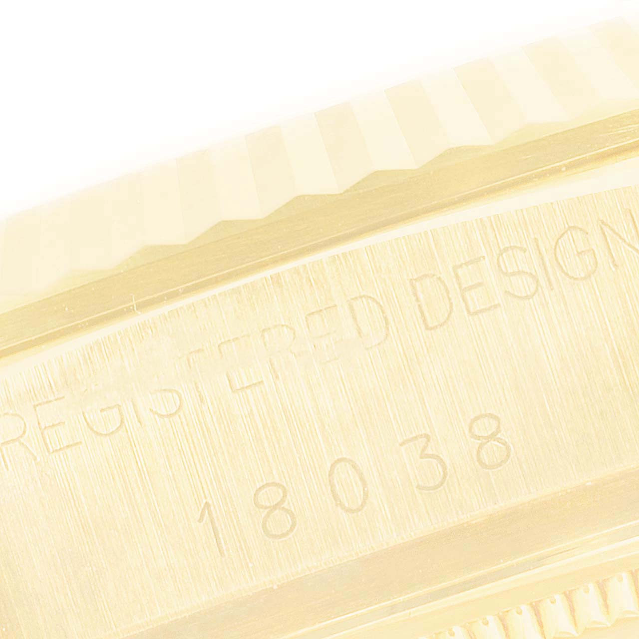 This image captures a close-up of the model number 18038 and part of the fluted bezel on the Rolex President 18038 Men
s Yellow Gold Champagne Dial 18038 Men
s Yellow Gold Champagne Dial watch.