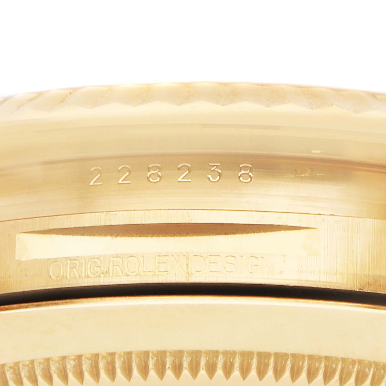 The image shows a close-up angle of the engraved side of the Rolex President 228238 Men's Yellow Gold Silver Dial model case.