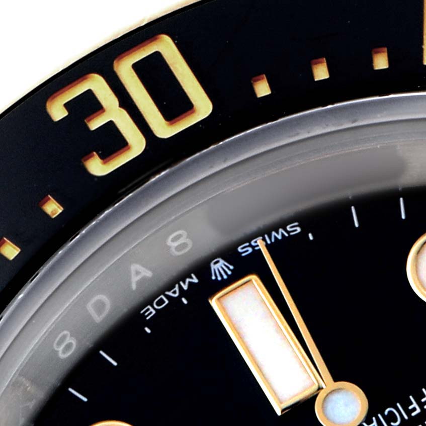 The image shows a close-up of the dial and the bezel of a Rolex Sea-Dweller 126603 Men's Steel and Gold (two tone) Black Dial, focusing on the 30-minute marker.