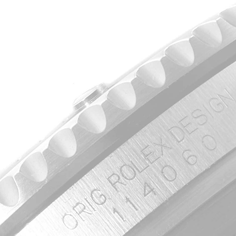 The image shows a close-up of the side of a Rolex Submariner 114060 Men
s Stainless Steel Black Dial 114060 Men
s Stainless Steel Black Dial watch, including the bezel and engraved model number.
