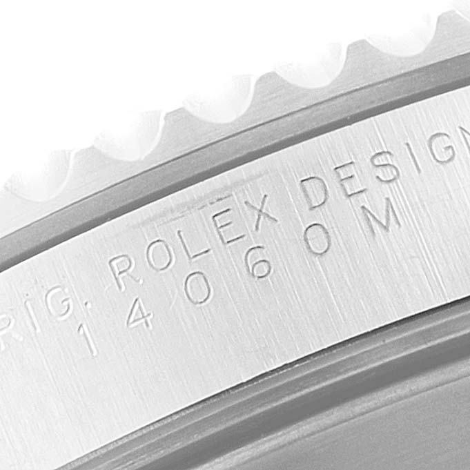 Close-up of the Rolex Submariner 14060 Men's Stainless Steel Black Dial 14060 Men's Stainless Steel Black Dial's case side, showing the engraved model number and "ROLEX DESIGN".