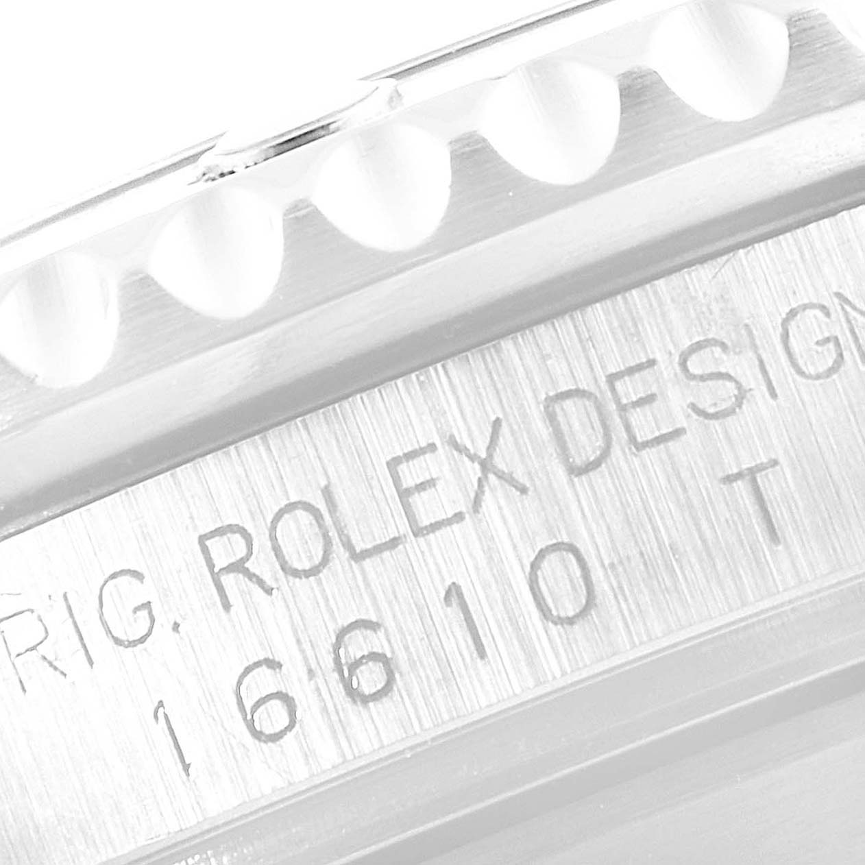 This image shows an angled close-up of the engraving on the side of a Rolex Submariner 16610 Men
s Stainless Steel Black Dial 16610 Men
s Stainless Steel Black Dial watch case.