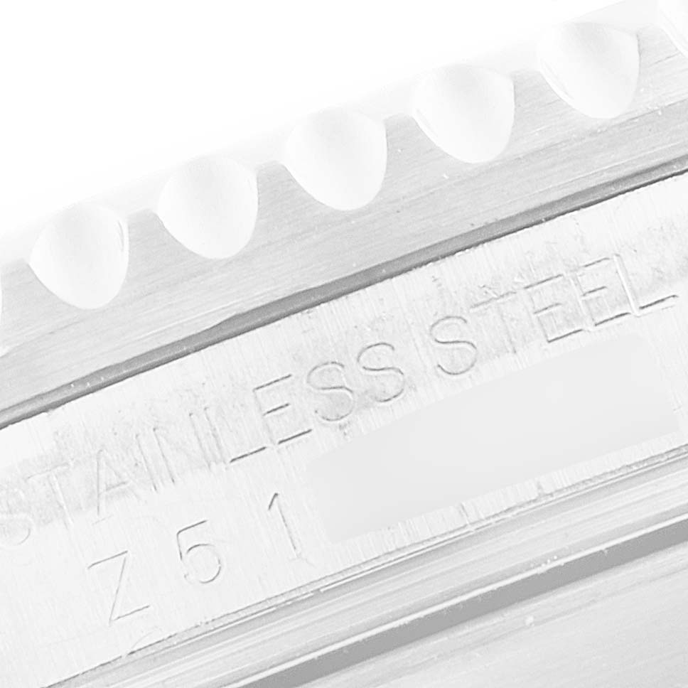 The image shows a close-up of the bezel and case side of a Rolex Submariner 16610 Men
s Stainless Steel Black Dial 16610 Men
s Stainless Steel Black Dial, highlighting the engraving "STAINLESS STEEL."