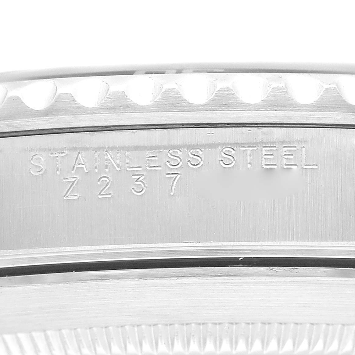 This image shows a close-up of the engraved stainless steel case side of a Rolex Submariner 14060 Men
s Stainless Steel Black Dial 14060 Men
s Stainless Steel Black Dial watch.