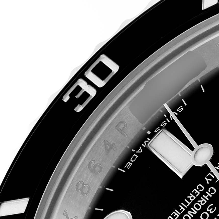 The image shows a close-up of the bezel and partial dial of a Rolex Submariner 114060 Men's Stainless Steel Black Dial watch.