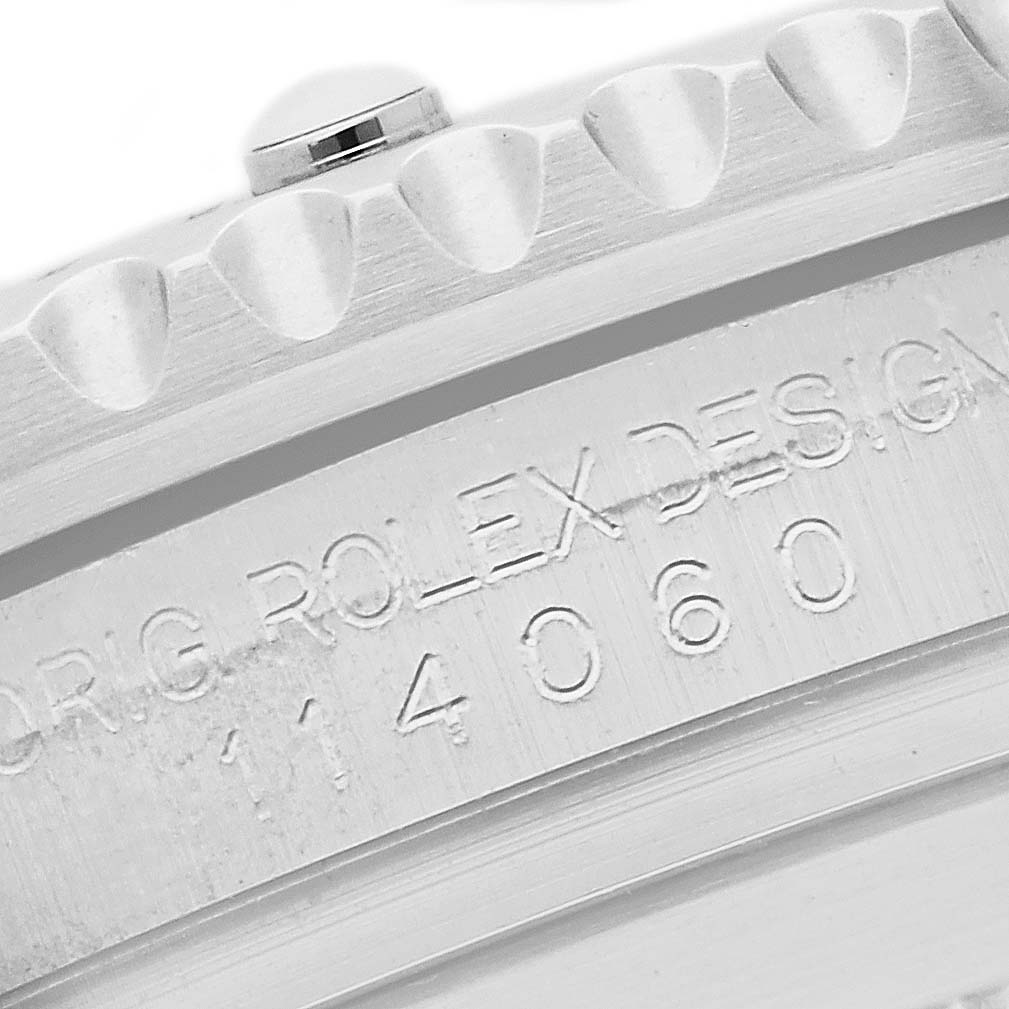 The image shows a close-up of the engraved inner bezel or flange of a Rolex Submariner 114060 Men's Stainless Steel Black Dial, displaying the model number.