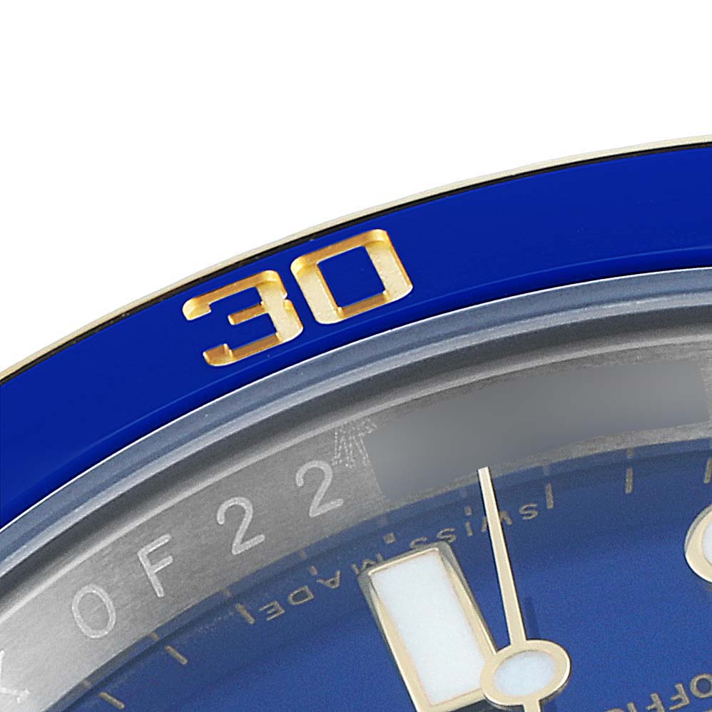 This image shows a close-up of the bezel and partial dial of the Rolex Submariner 116613 Men's Steel and Gold (two tone) Blue Dial 116613 Men's Steel and Gold (two tone) Blue Dial watch.
