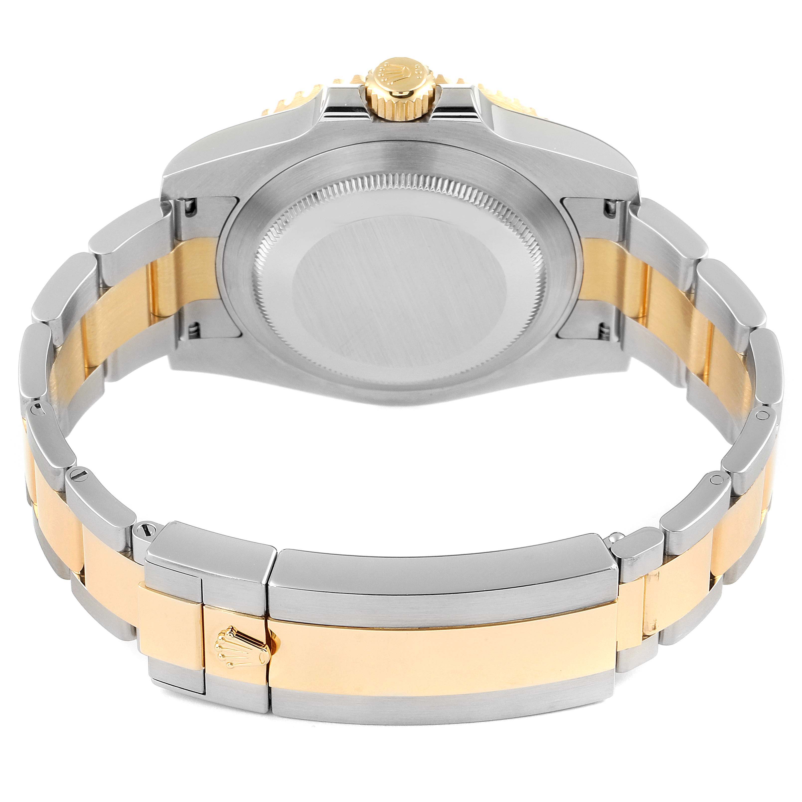 This image shows the back view of a Rolex Submariner 116613 Men's Steel and Gold (two tone) Blue Dial 116613 Men's Steel and Gold (two tone) Blue Dial watch, highlighting the stainless steel and gold band along with the case back.