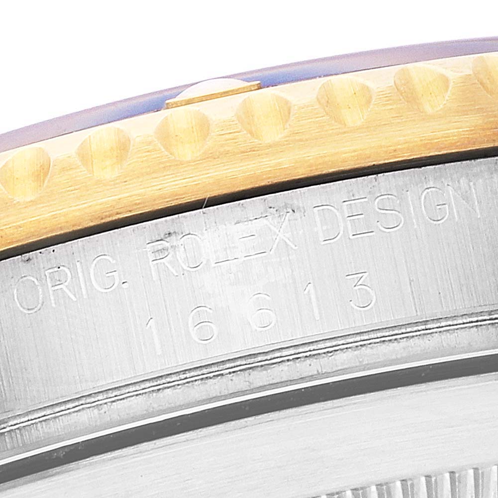 This close-up image of the Rolex Submariner 16613 Men
s Steel and Gold (two tone) Grey Dial 16613 Men
s Steel and Gold (two tone) Grey Dial shows the engraved model number on the side of the casing.