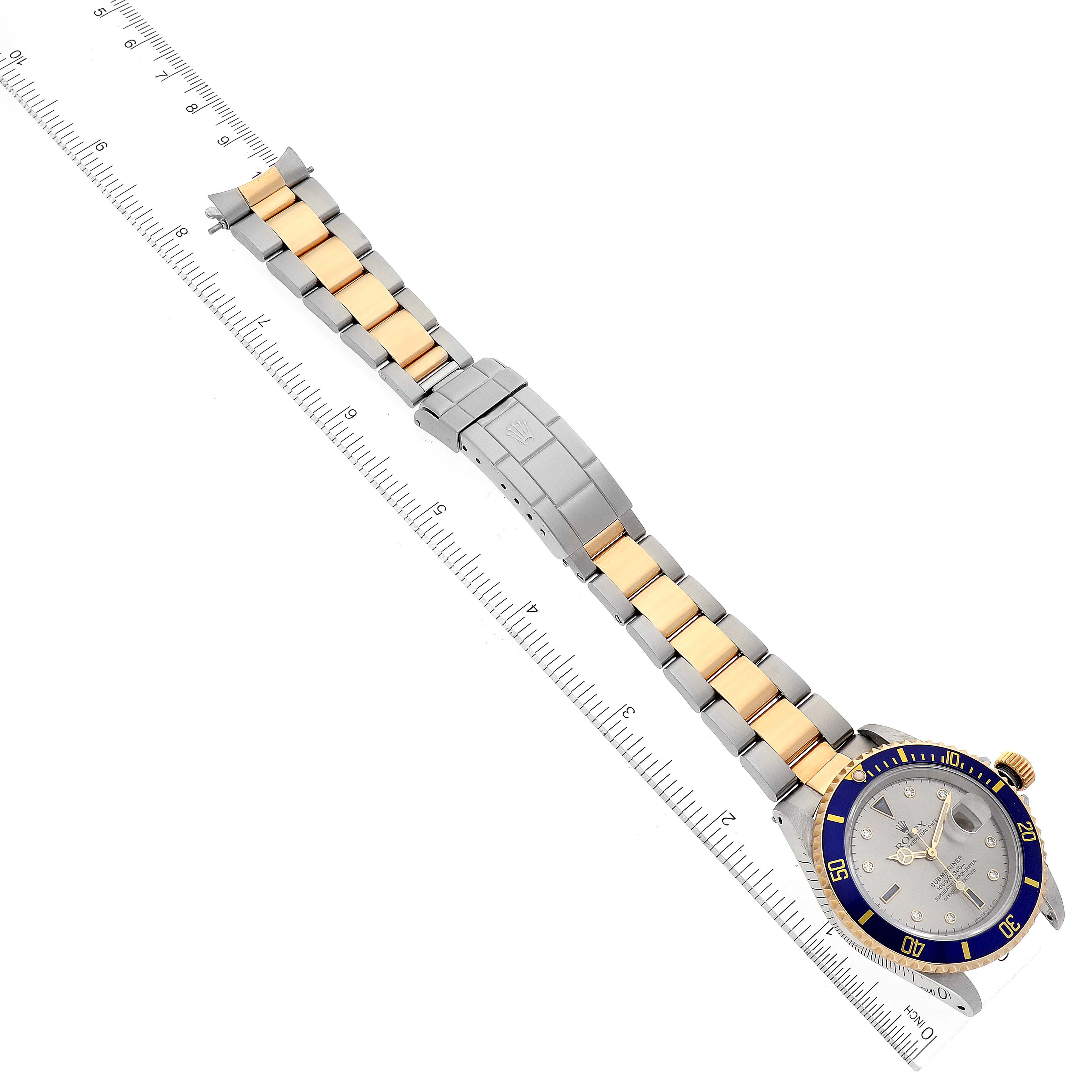 The image showcases a Rolex Submariner 16613 Men
s Steel and Gold (two tone) Grey Dial 16613 Men
s Steel and Gold (two tone) Grey Dial watch, featuring the face, bezel, and bracelet from a top-down angle.