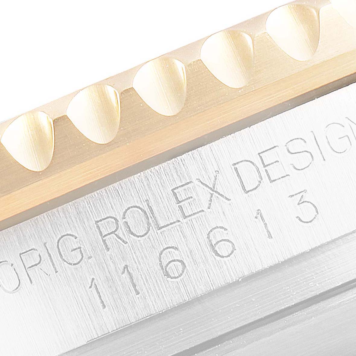 Close-up of the bezel and engraved reference number of a Rolex Submariner 116613 Men's Steel and Gold (two tone) Black Dial 116613 Men's Steel and Gold (two tone) Black Dial watch.